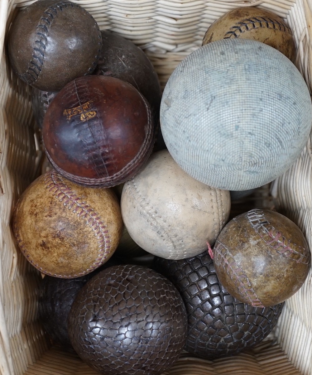 A collection of leather cricket and sporting balls